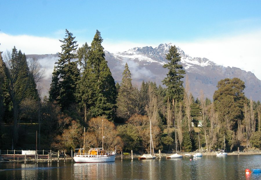 Boats moored on the lake below the snow line